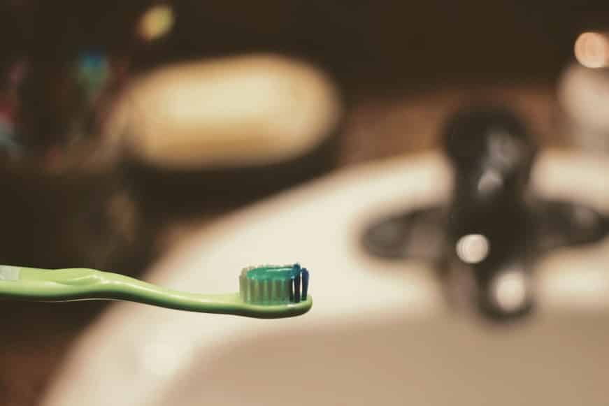 green toothpaste in a toothbrush