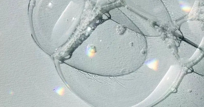 Rainbow soap bubble on white surface