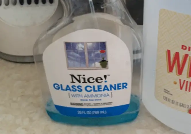 Two bottles of cleaning products: glass cleaner with ammonia and vinegar