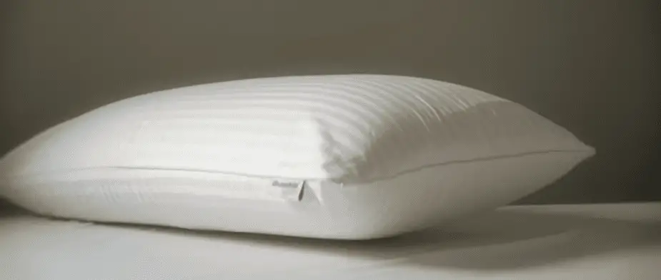 White pillow on a bed covered in snow