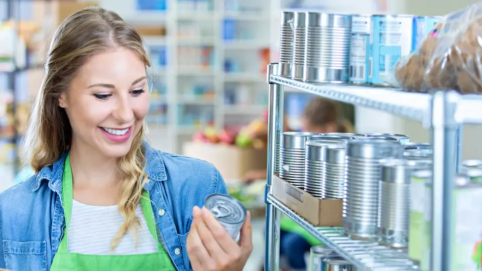 Woman checking canned goods