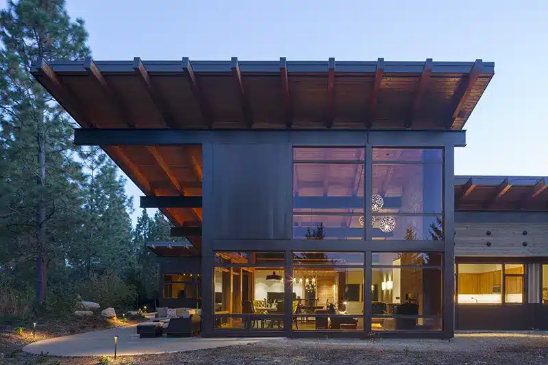 Modern house with many windows and a wooden roof