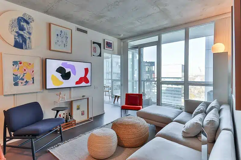 Living room with couch, chair, ottoman, and television