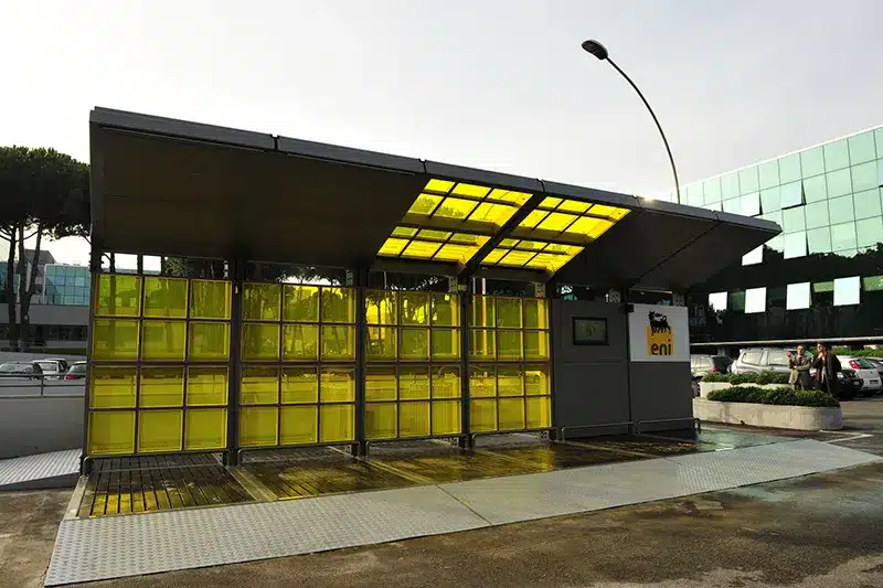 Bus stop with a yellow tinted glass roof 