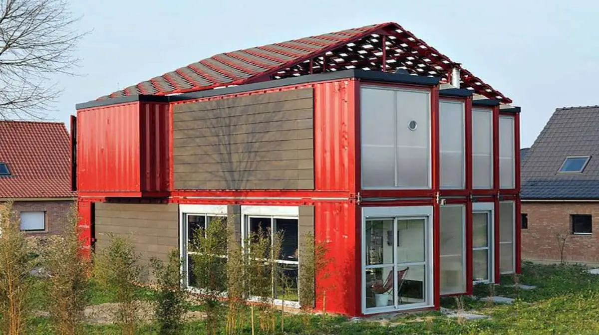 A red-colored container home showing its design and construction.