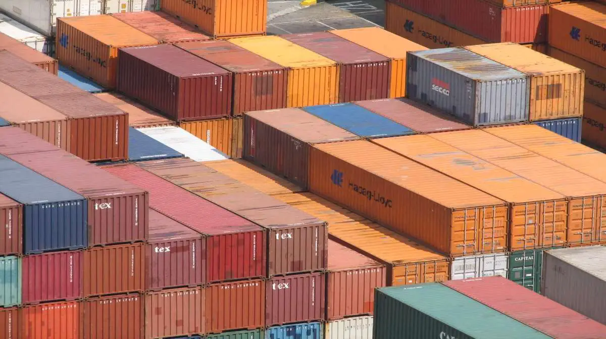 A pile of shipping containers with different sizes.