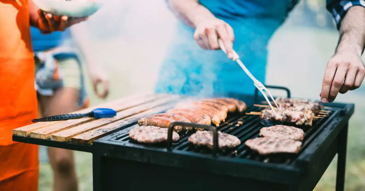 a man grilling meat outdoors