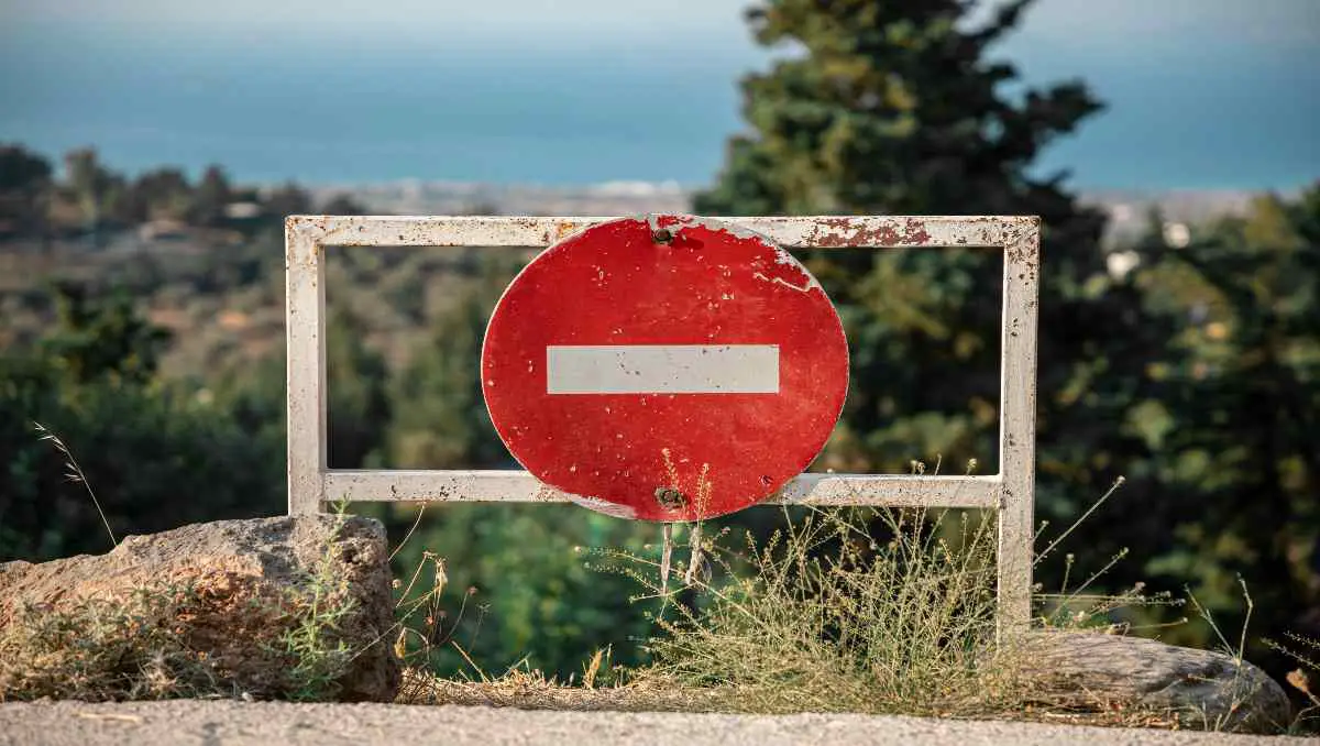 A red forbidden sign on the side of the road.