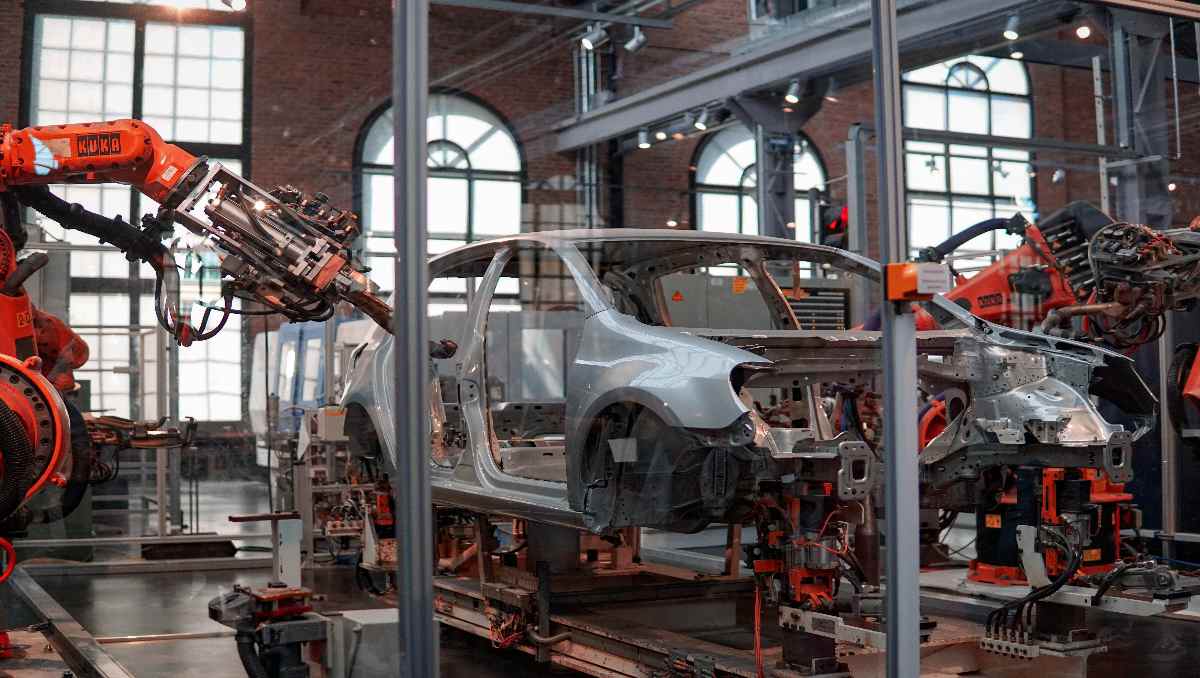 A gray automotive being fixed inside the factory. 