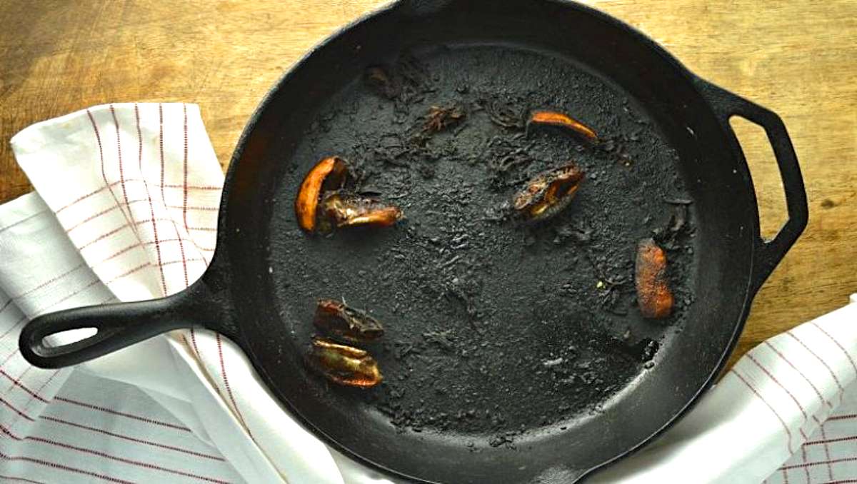 A burnt Teflon pan and a kitchen towel.