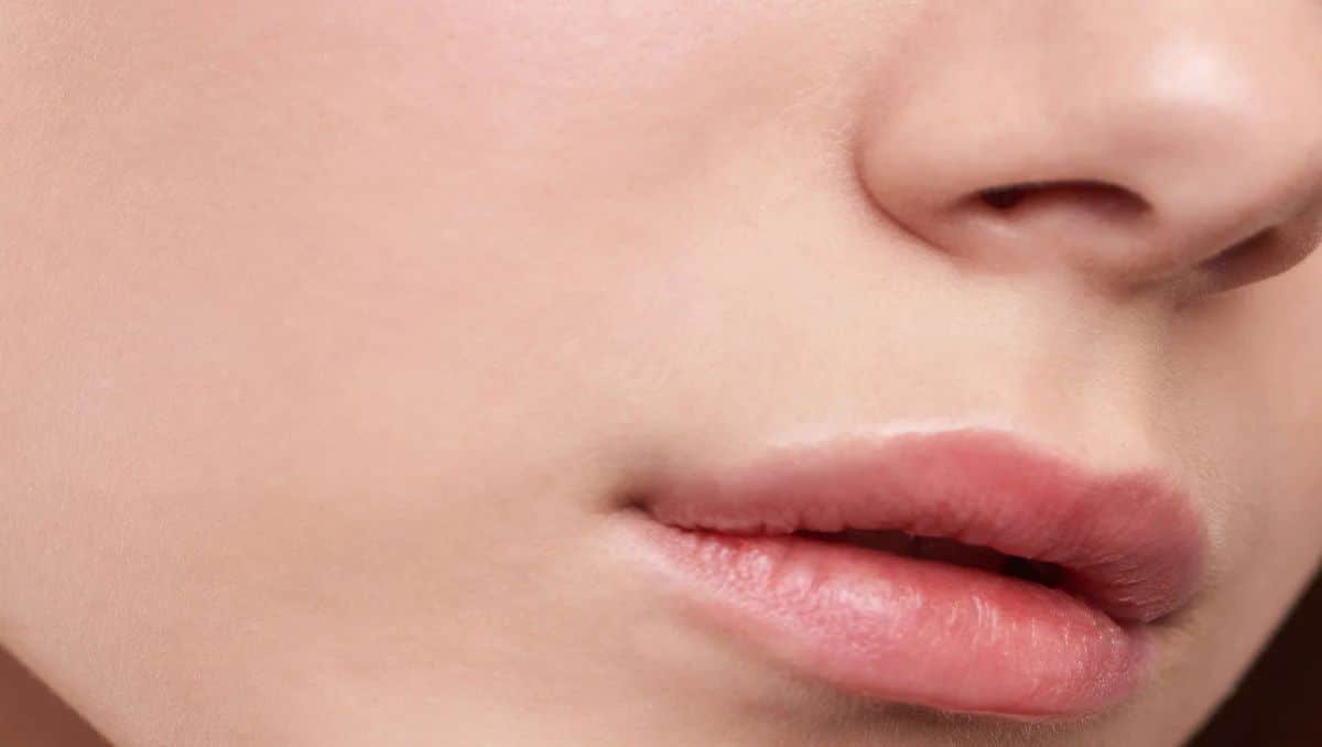 A closeup shot of a woman's cheek, nose and lips.