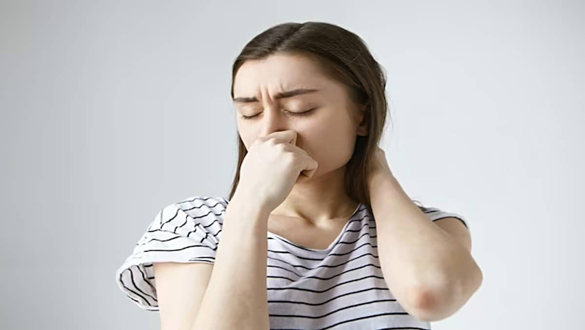 A woman covering her nose as indication for bad smell.