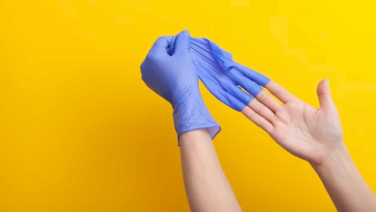 A hand demonstrating how to properly remove gloves.