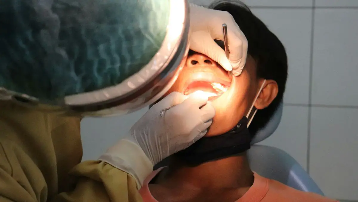 A dentist checking patient's teeth inside the clinic.
