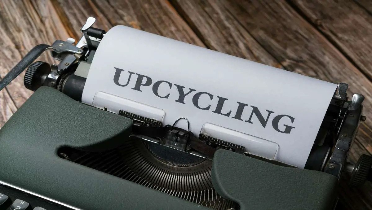 A typewriter and paper with the word "upcycling".